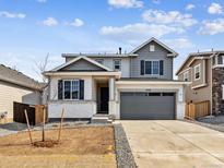 Charming two-story home featuring a two-car garage and neutral-tone siding at 9728 Cathay St, Commerce City, CO 80022