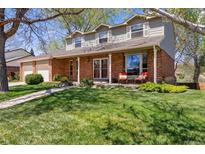 Charming two-story home with landscaped front yard and brick exterior at 6336 S Newland Ct, Littleton, CO 80123