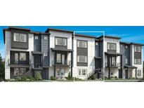 Modern townhome featuring a stylish facade with contrasting colors, clean lines, and private balconies at 682 Belay St, Erie, CO 80516