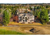 Stunning estate home overlooking the lush golf course with manicured lawn and mature landscaping at 73 Glenmoor Dr, Cherry Hills Village, CO 80113