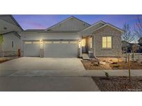 Charming single Gathering home featuring a three car garage, stone accents, and manicured landscaping at 24593 E 34Th Ave, Aurora, CO 80019