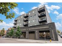 Striking condo building with black trim, balconies, and contemporary design stands out against the blue sky at 1300 N Ogden St # 204, Denver, CO 80218