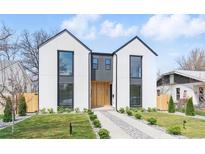 Modern two-story home with light exterior, black trim, rock pathway, and minimalist landscaping at 3047 S Cherokee St, Englewood, CO 80110