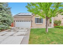 Charming single-Gathering home features a two-car garage, solar panels, and well-maintained lawn at 18619 E Vassar Dr, Aurora, CO 80013