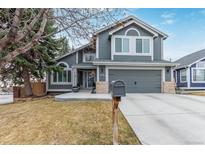 Inviting two-story home featuring a well-manicured lawn and an attached two-car garage at 9208 W 100Th Pl, Broomfield, CO 80021