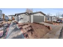 Ranch style home with detached garage and storage shed at 2017 Tulane St, Denver, CO 80260