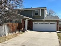 Charming two-story home with a two car garage, brick accents, and a well-maintained front yard at 5612 S Lansing Ct, Englewood, CO 80111