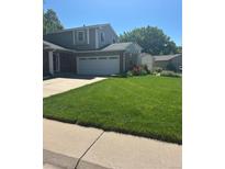 Well maintained two story home, with a beautiful lawn, driveway, and attached two car garage at 5612 S Lansing Ct, Englewood, CO 80111