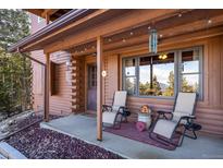 Cozy covered porch offers comfortable seating and scenic views of the surrounding landscape at 636 Chute Rd, Golden, CO 80403