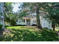 Charming home featuring a well-manicured lawn and inviting curb appeal shaded by mature trees at 4675 S Yosemite St # 205, Denver, CO 80237
