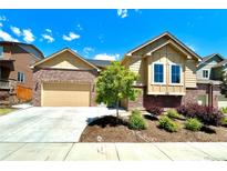 Charming home featuring a brick and siding exterior, well-manicured landscaping and an attached two car garage at 425 W 128Th Dr, Westminster, CO 80234
