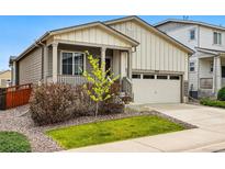 Charming home featuring a cozy front porch, attached two-car garage, and well-maintained landscaping at 3548 Swabuck Pl, Castle Rock, CO 80109