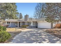 Charming single-story home with a brick facade, attached garage, and well-maintained landscaping at 2 N Jasmine St, Denver, CO 80220