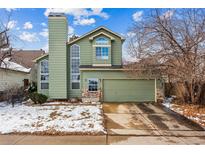Charming two-story home features a two-car garage, tall chimney and large windows at 12667 Meade St, Broomfield, CO 80020