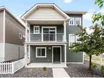 Charming two-story home with a covered front porch and a manicured yard, perfect for enjoying the outdoors at 17767 E 54Th Ave, Denver, CO 80249