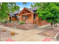 Charming brick home with a well-maintained front yard and raised garden beds at 3002 Quitman St, Denver, CO 80212