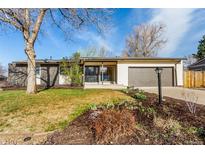 Charming ranch-style home with a well-manicured front yard and attached garage at 6052 Taft St, Arvada, CO 80004