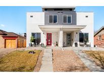Modern duplex with xeriscaped front yard, concrete steps, and covered porches featuring a red door at 1333 Raleigh St, Denver, CO 80204