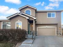 Two-story house with attached garage and landscaping at 10094 Wyandott Cir, Denver, CO 80260