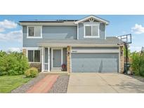 Charming two-story home with a stone accents, a basketball hoop and a well-maintained yard at 19707 E Caspian Cir, Aurora, CO 80013