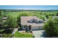 Charming two-story home with well-manicured lawn, mature trees, and three car garage at 984 Shadow Mountain Dr, Highlands Ranch, CO 80126