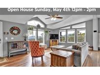 Open living room featuring high ceilings, large windows with mountain views, and stylish furnishings at 248 Copperdale Ln, Golden, CO 80403