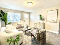 Bright living room with a large window, plush seating, and stylish decor at 4816 W 8Th Ave, Denver, CO 80204