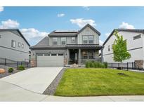 Charming two-story home with a well-manicured lawn and solar panels on the roof at 3365 S Poppy St, Morrison, CO 80465