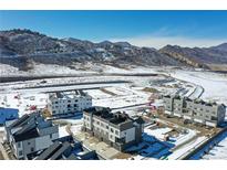 New townhomes under construction with mountain views in a snowy landscape at 14422 Pansy Loop, Morrison, CO 80465