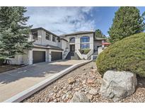 Stately two-story home with an impressive entry staircase and a two-car garage at 6961 Salvia St, Arvada, CO 80007