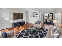 Comfortable living room with modern decor, stylish rug, and a large screen television for entertaining at 1342 S Andes St, Aurora, CO 80017