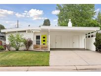 Charming mid-century modern home featuring a bright, eye-catching front door and covered carport at 260 S Jasmine St, Denver, CO 80224