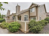 Charming exterior view of townhome featuring a wood facade and chimney, surrounded by lush landscaping at 6839 Zenobia St # 3, Westminster, CO 80030