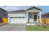 Charming single-Gathering home featuring a two-car garage and welcoming front porch at 18338 E 93Rd Pl, Commerce City, CO 80022