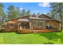 Stunning wood home featuring an expansive deck perfect for entertaining and relaxing outdoors at 4407 Delaware Dr, Larkspur, CO 80118