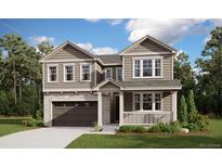 Charming two-story home with stone accents, a two-car garage, a covered porch, and manicured landscaping at 700 Lawson Dr, Elizabeth, CO 80107