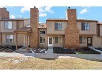 Charming townhome featuring a private entry, brick chimney, and well-kept front yard at 892 Summer Dr # 15B, Highlands Ranch, CO 80126