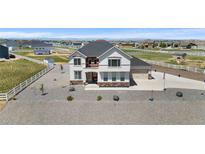 Two-story home with stone accents, gray roof, white fence, and gravel landscaping at 16197 Paris Way, Brighton, CO 80602