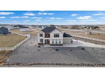 Charming two-story home featuring stone accents, a three-car garage, and a spacious gravel front yard at 16197 Paris Way, Brighton, CO 80602