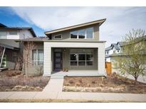 Contemporary home with modern architecture, a covered entryway, and tidy landscaping, offering curb appeal at 5050 Akron St, Denver, CO 80238