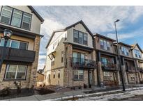 Attractive townhome exteriors with stone accents, balconies, and well-maintained landscaping at 11830 W 52Nd Ave, Wheat Ridge, CO 80033