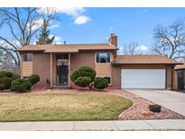 Charming brick two-story home with a well-maintained lawn and a two car garage at 9720 W Kentucky Dr, Lakewood, CO 80226