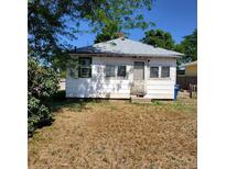 Quaint white home with gray roof, small front yard, and classic charm at 150 Fulton Ave, Fort Lupton, CO 80621