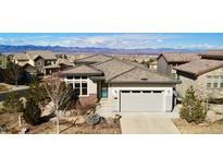 Charming single-Gathering home featuring well-maintained landscaping and a two-car garage with mountain views at 775 Woodgate Dr, Highlands Ranch, CO 80126