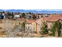 Beautiful exterior view of a home in a neighborhood with a mountain view at 9581 Firenze Way, Highlands Ranch, CO 80126