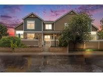 Charming exterior with stone accents and fresh landscaping, creating a welcoming curb appeal at 13275 Holly St # E, Thornton, CO 80241