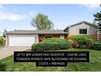Charming single-story home with well-maintained lawn and attached two-car garage at 3322 Simms St, Wheat Ridge, CO 80033