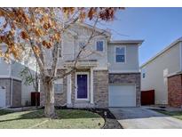 Charming two-story home with brick accents, a well-maintained lawn, and a delightful tree in the front yard at 3734 Dexter St, Denver, CO 80207