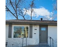 Charming home featuring gray trim, a stone foundation, and an inviting gray front door with decorative glass at 1601 S Zuni St, Denver, CO 80223