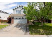 Charming two-story home showcasing a well-manicured front yard and a two car garage at 4715 E 127Th Dr, Thornton, CO 80241